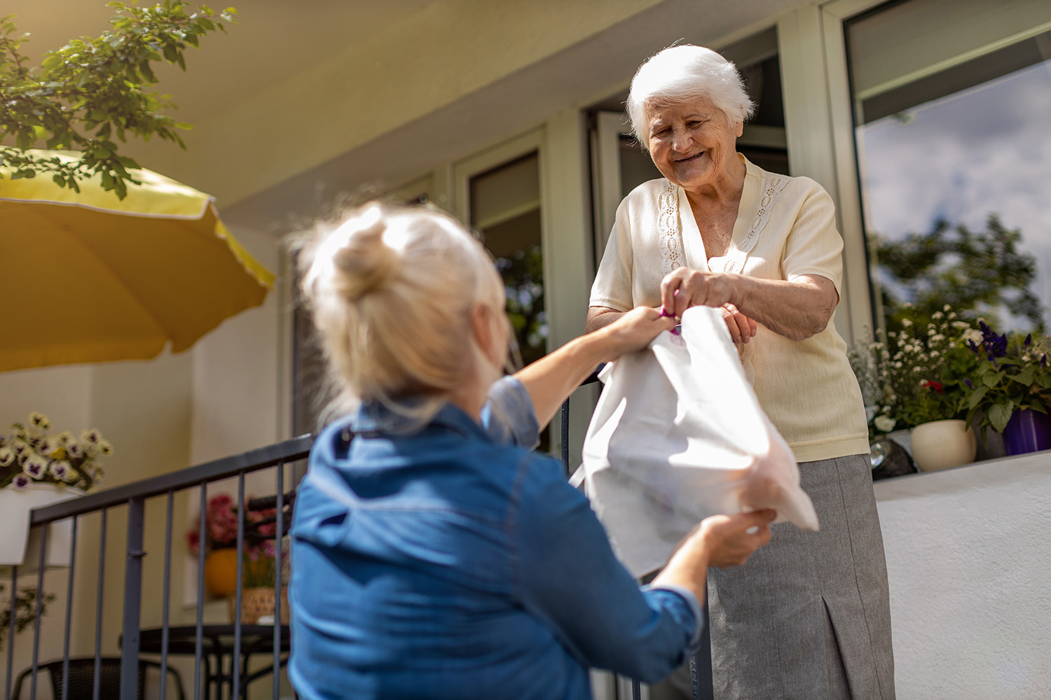 one woman handing food to another 