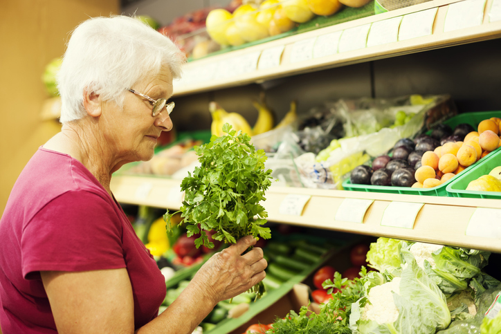 a woman picking out food at a store