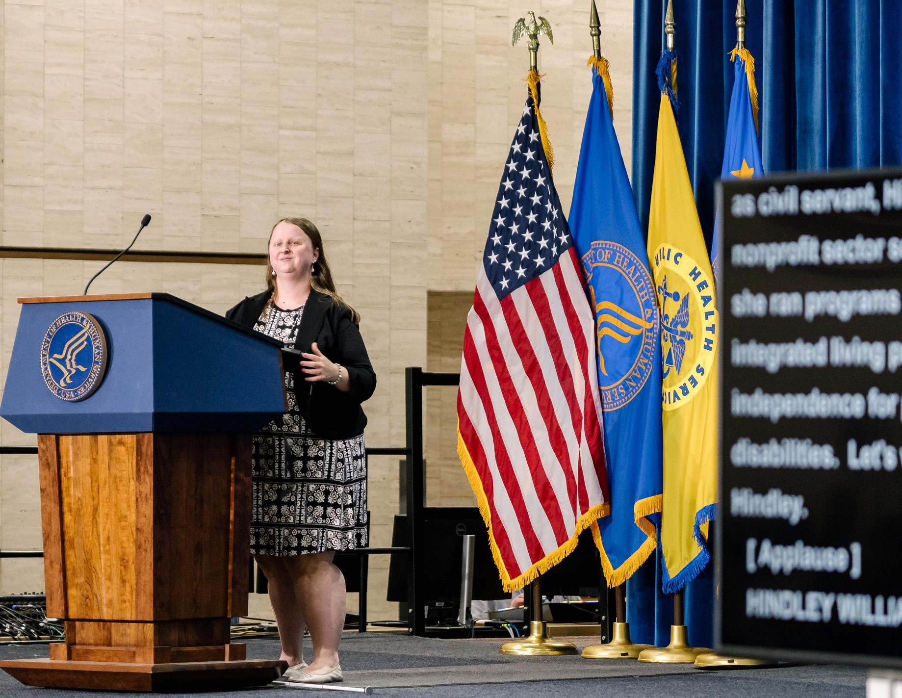 ACL Program Analyst Hindley Williams speaking on stage at the podium during the ADA 35th Anniversary event