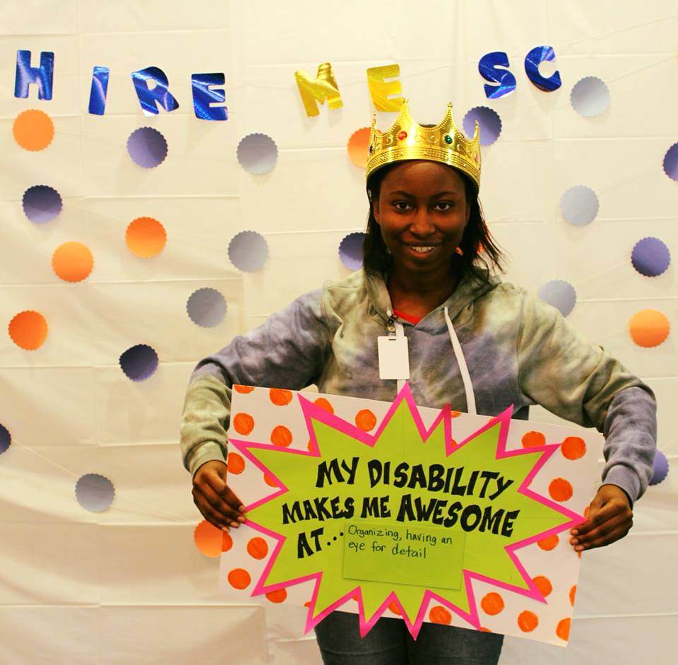 Girl Holding Sign "My Disability Makes Me Awesome At... Organizing, having an eye for detail"