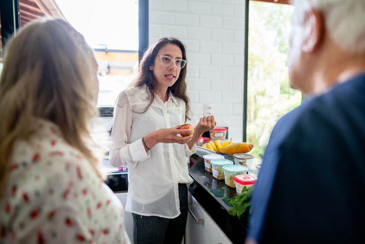 women talking over some food