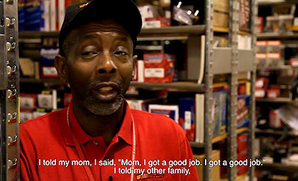 still from a video about workers with disability at an auto store